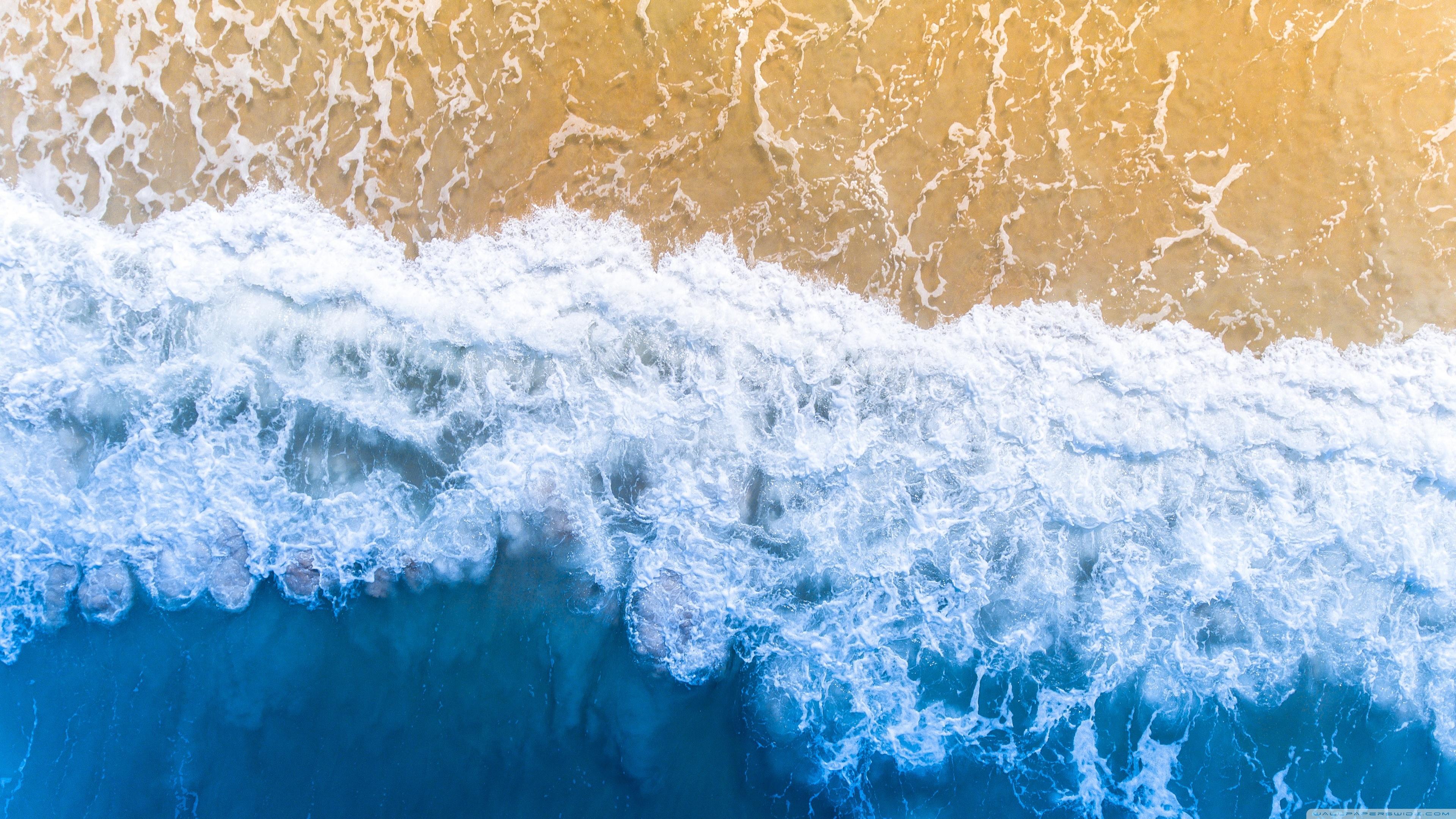 An aerial view of a beach with waves - Ocean, wave
