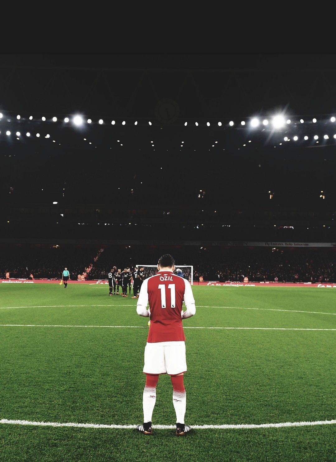 A soccer player standing on the field - Soccer