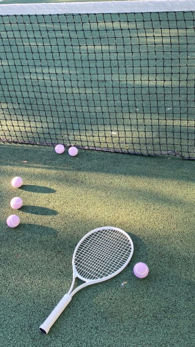 A tennis court with pink balls and racket - Tennis