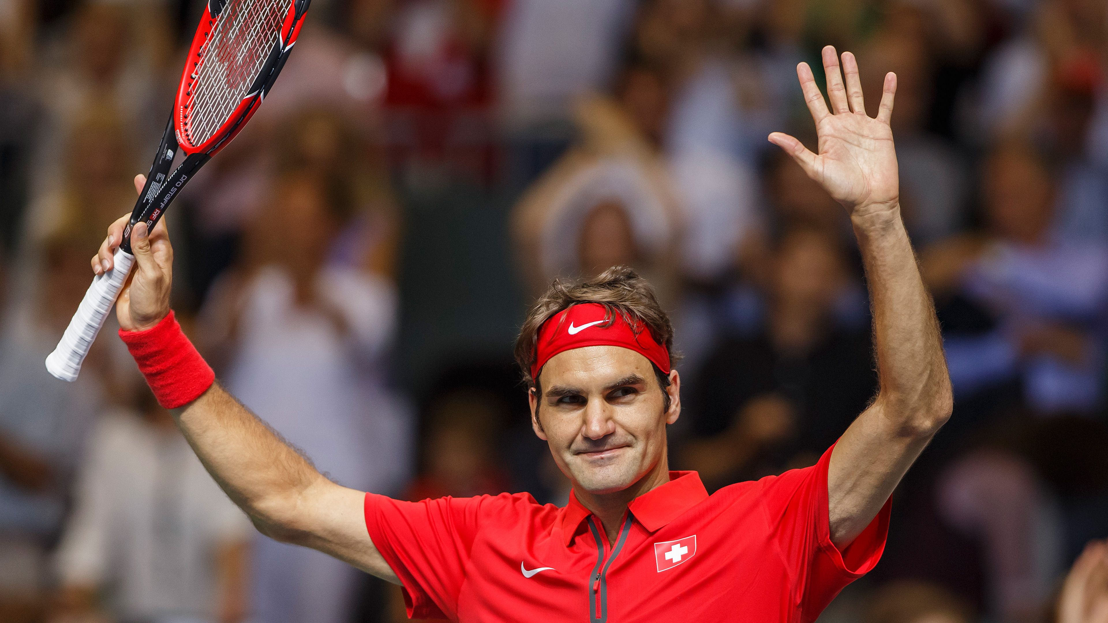 A man holding up his tennis racket - Tennis