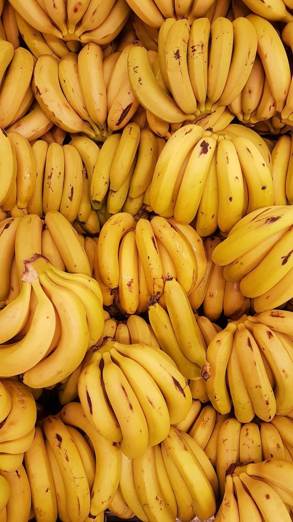 A bunch of bananas that are yellow - Banana