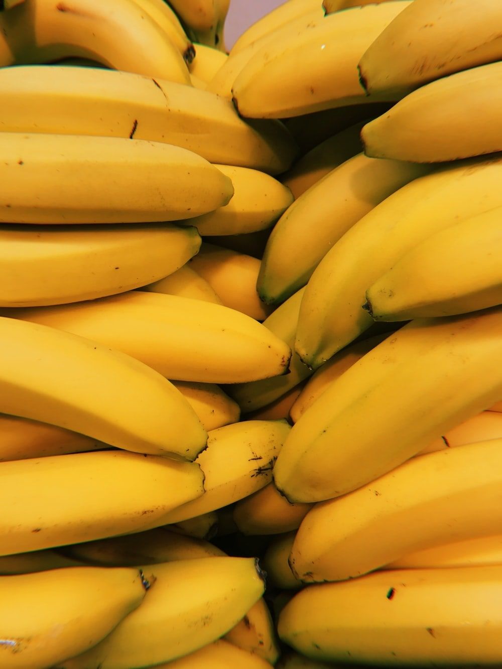 A bunch of bananas that are stacked together - Banana