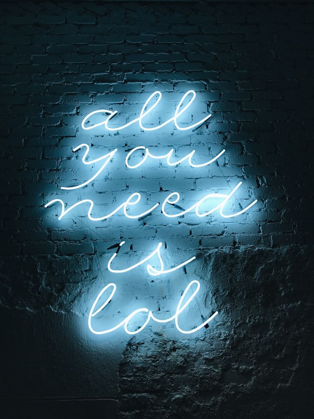 A neon sign that says all you need is lol - Navy blue