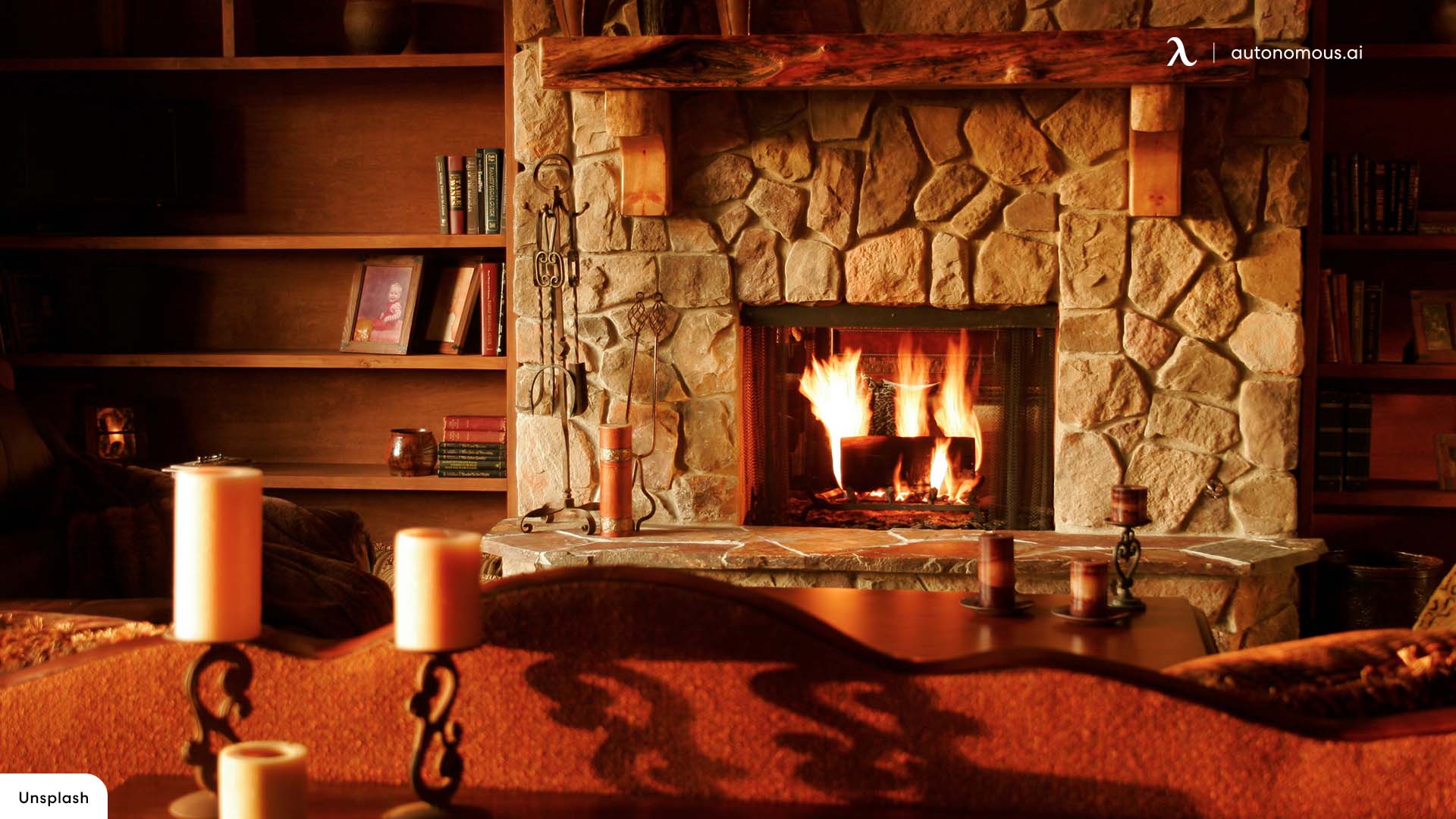 A fireplace with candles and books in the background - Cozy, warm