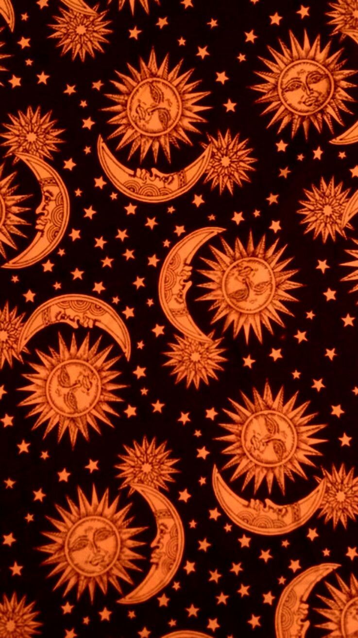 An orange and black pattern of suns, moons, and stars. - Positivity, sun