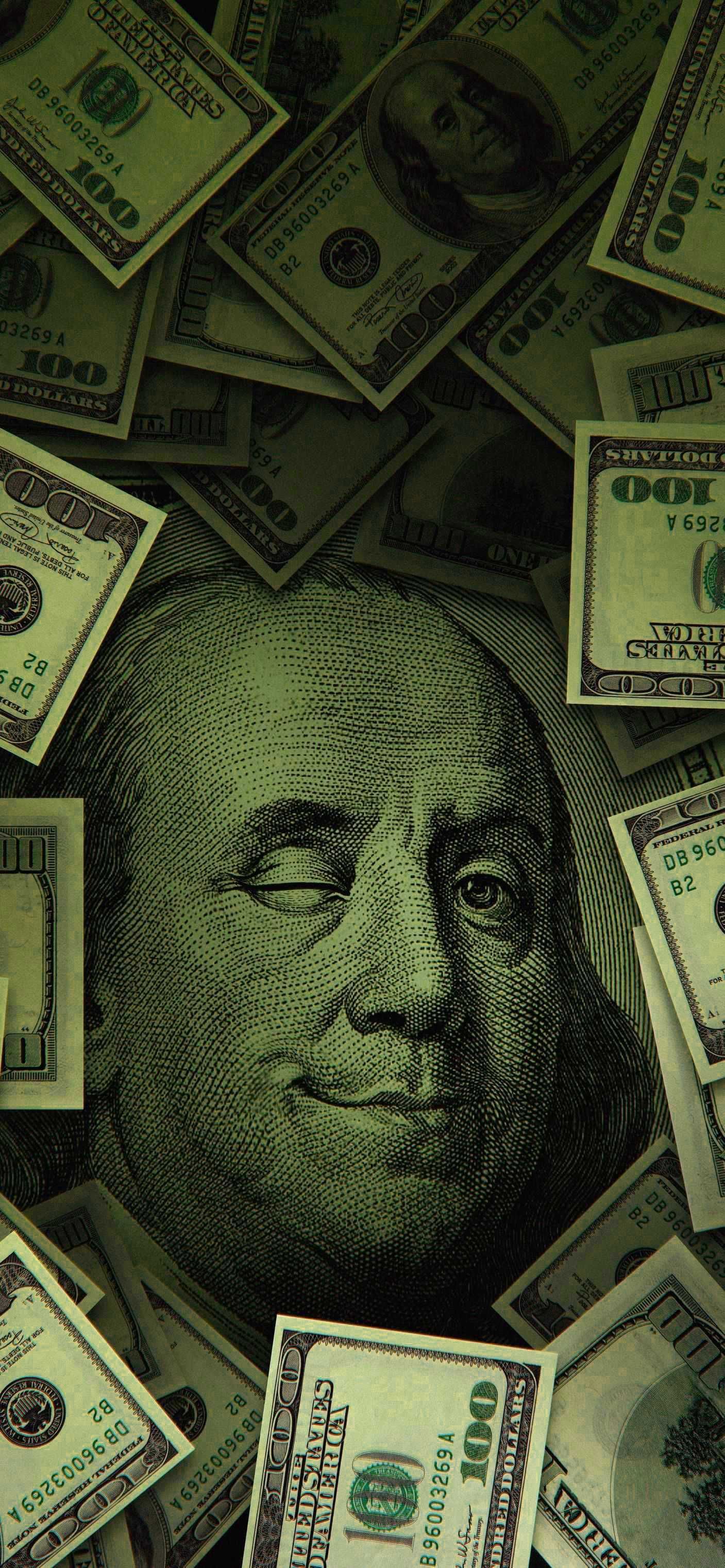 Benjamin Franklin's face on a pile of money - Money