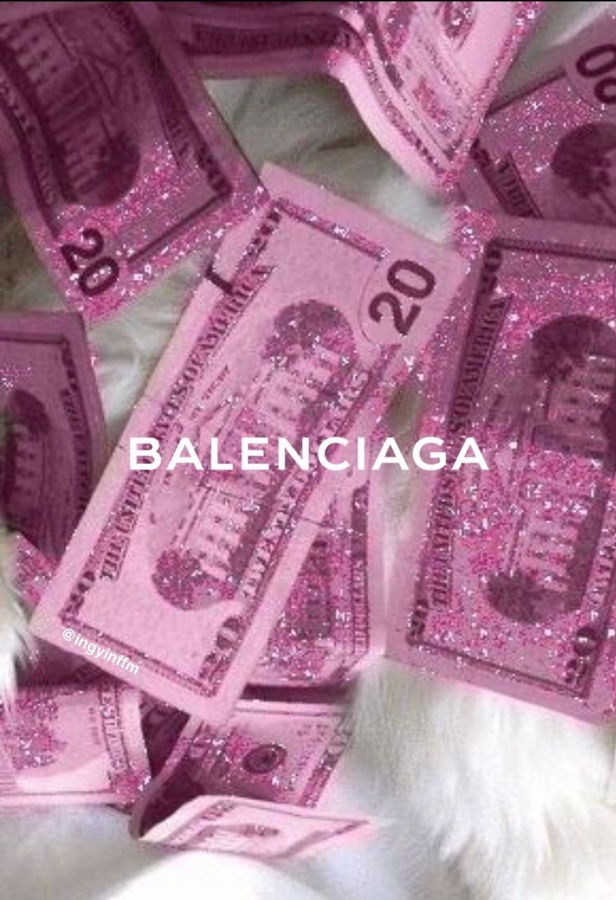 A cat sitting on top of pink money - Money