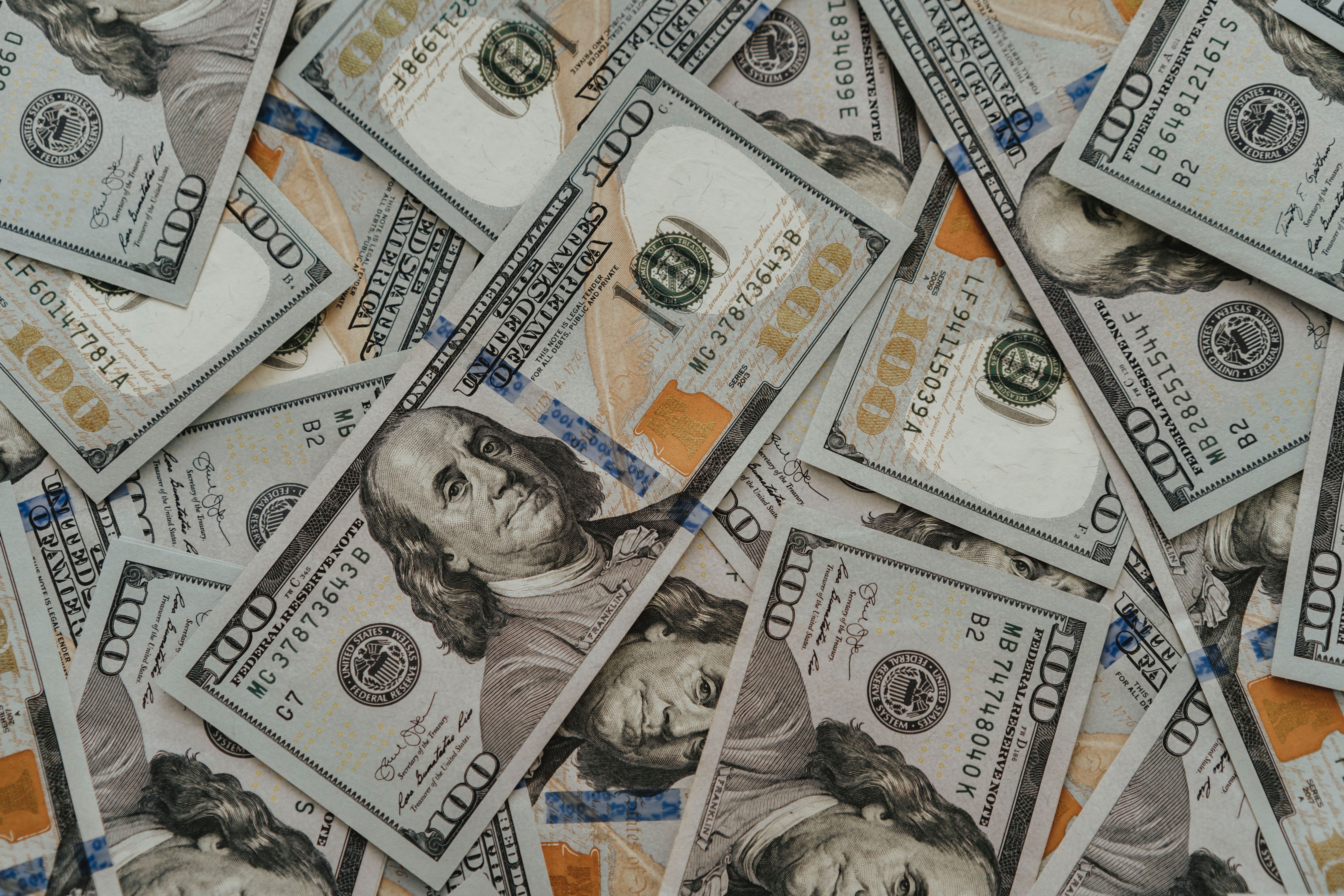 A close up of a pile of 100 dollar bills - Money