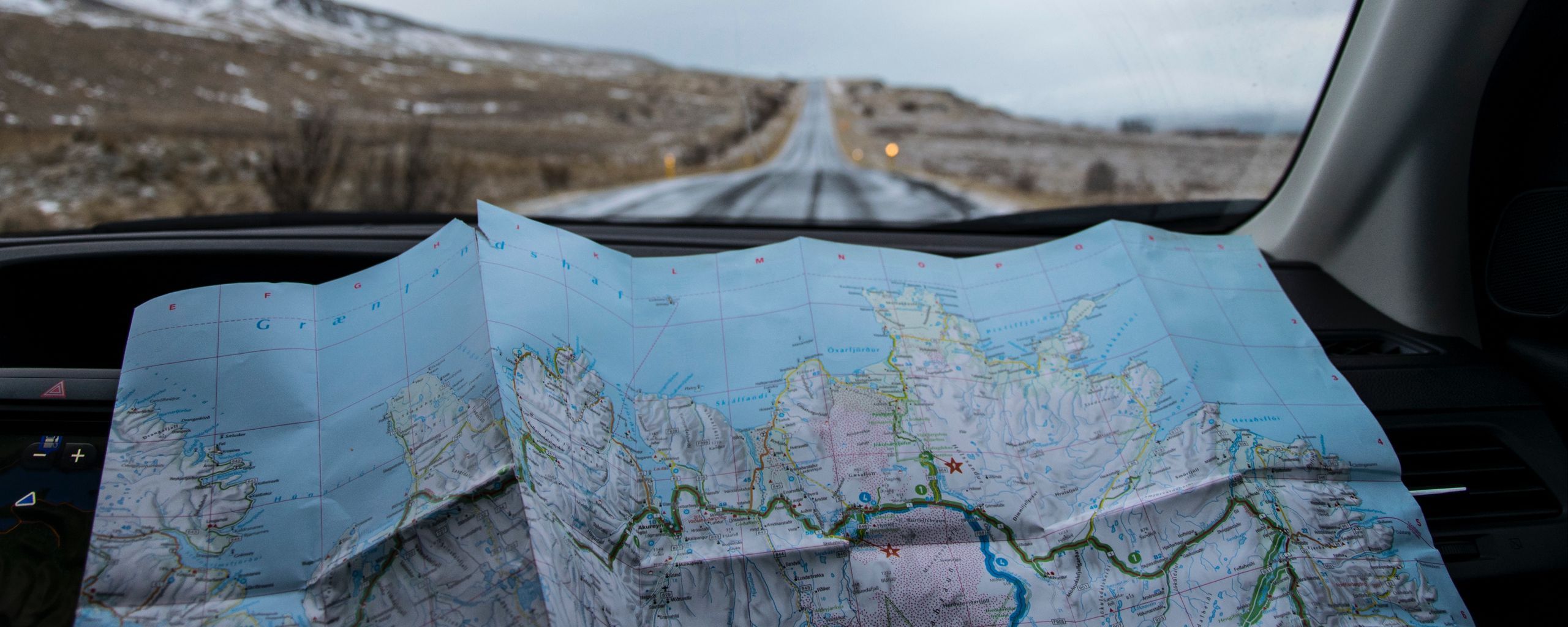 A map in a car with a road ahead - Travel