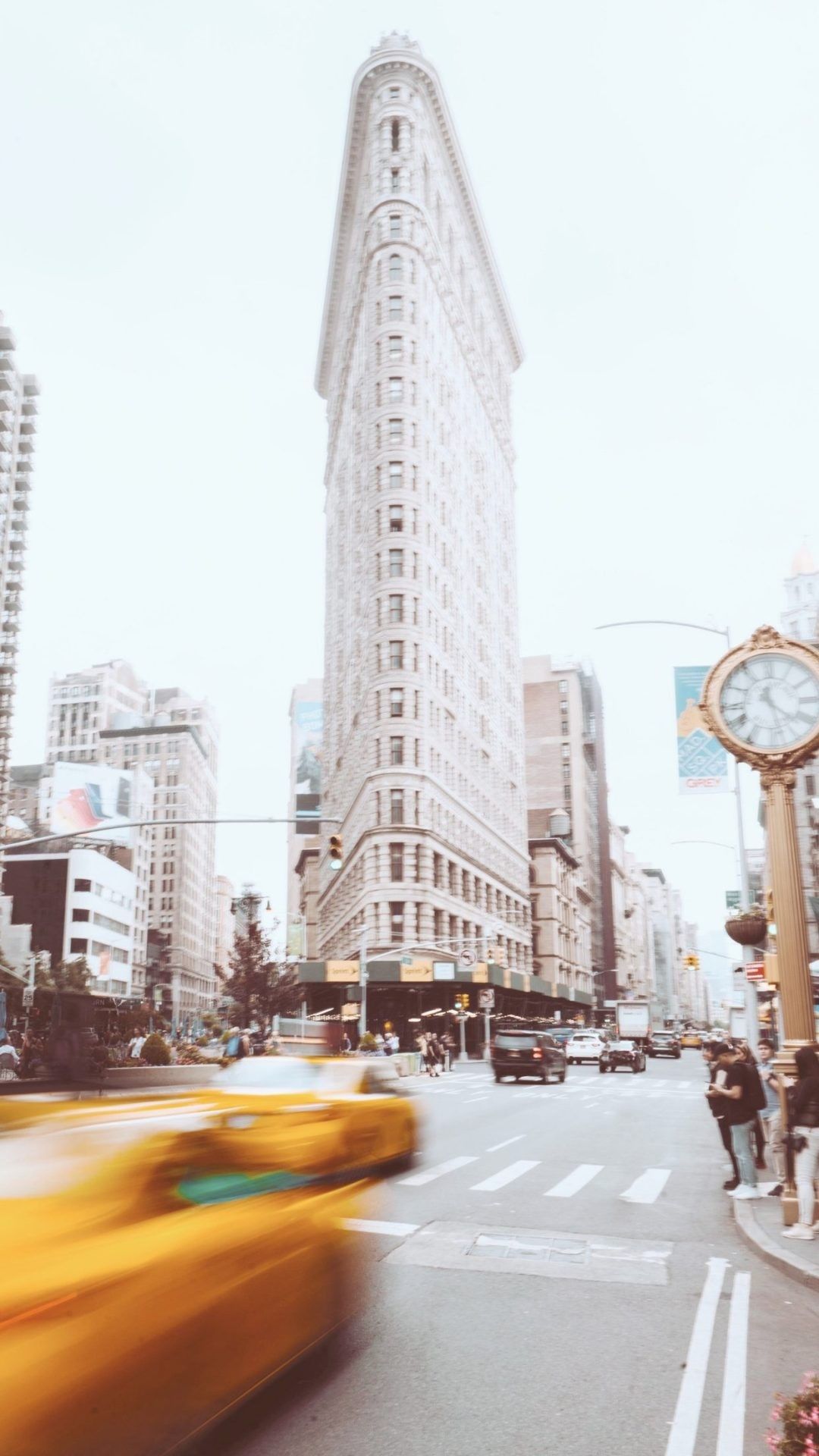 A blurry image of a yellow taxi driving by a tall building. - Travel, New York