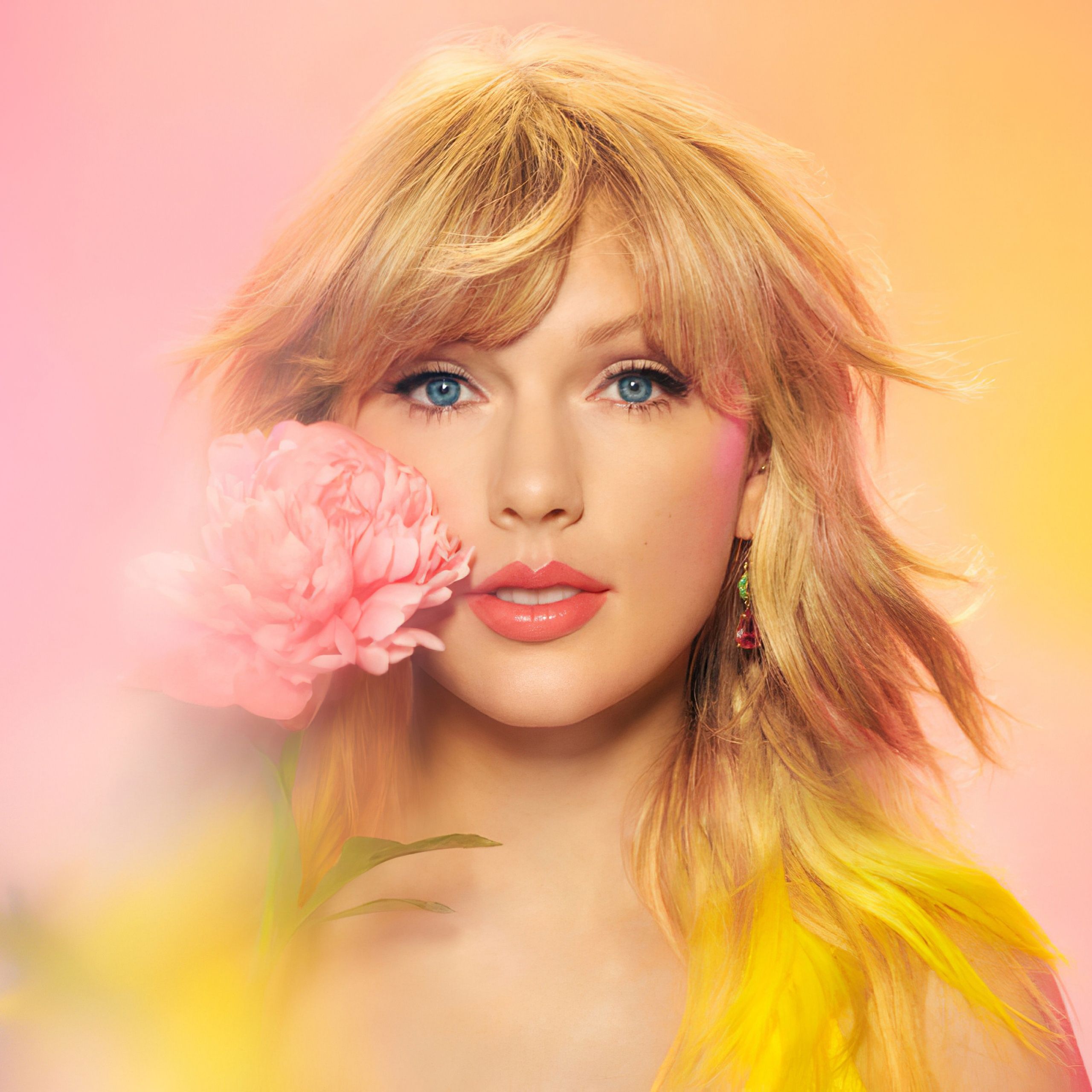Taylor Swift holding a pink flower in front of her face - Taylor Swift