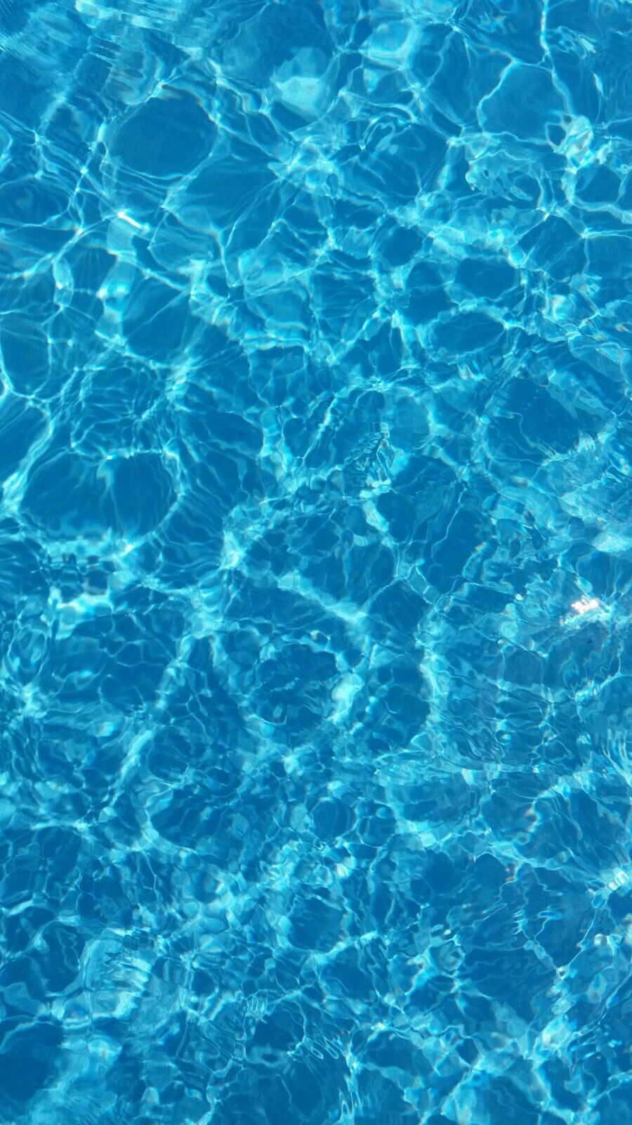 The surface of a pool with blue water - Water