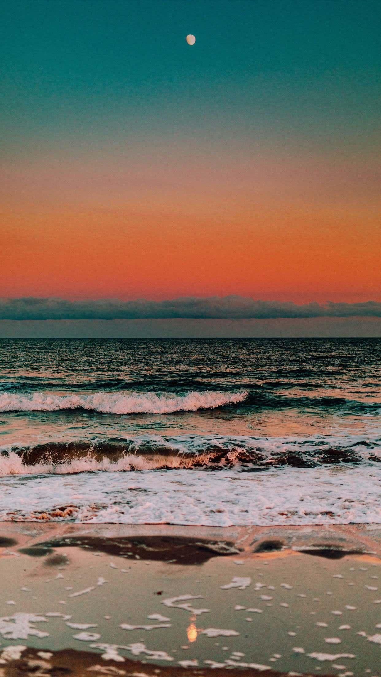 A photo of the ocean at sunset with the moon in the sky. - Photography, water, beach, summer, sunset, tropical, coast, ocean