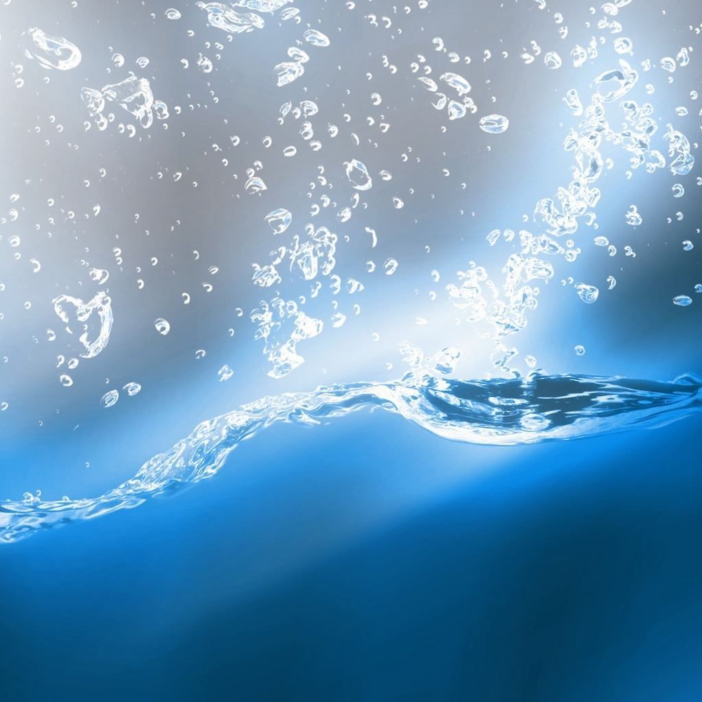 A water splashing on the surface of blue background - Water