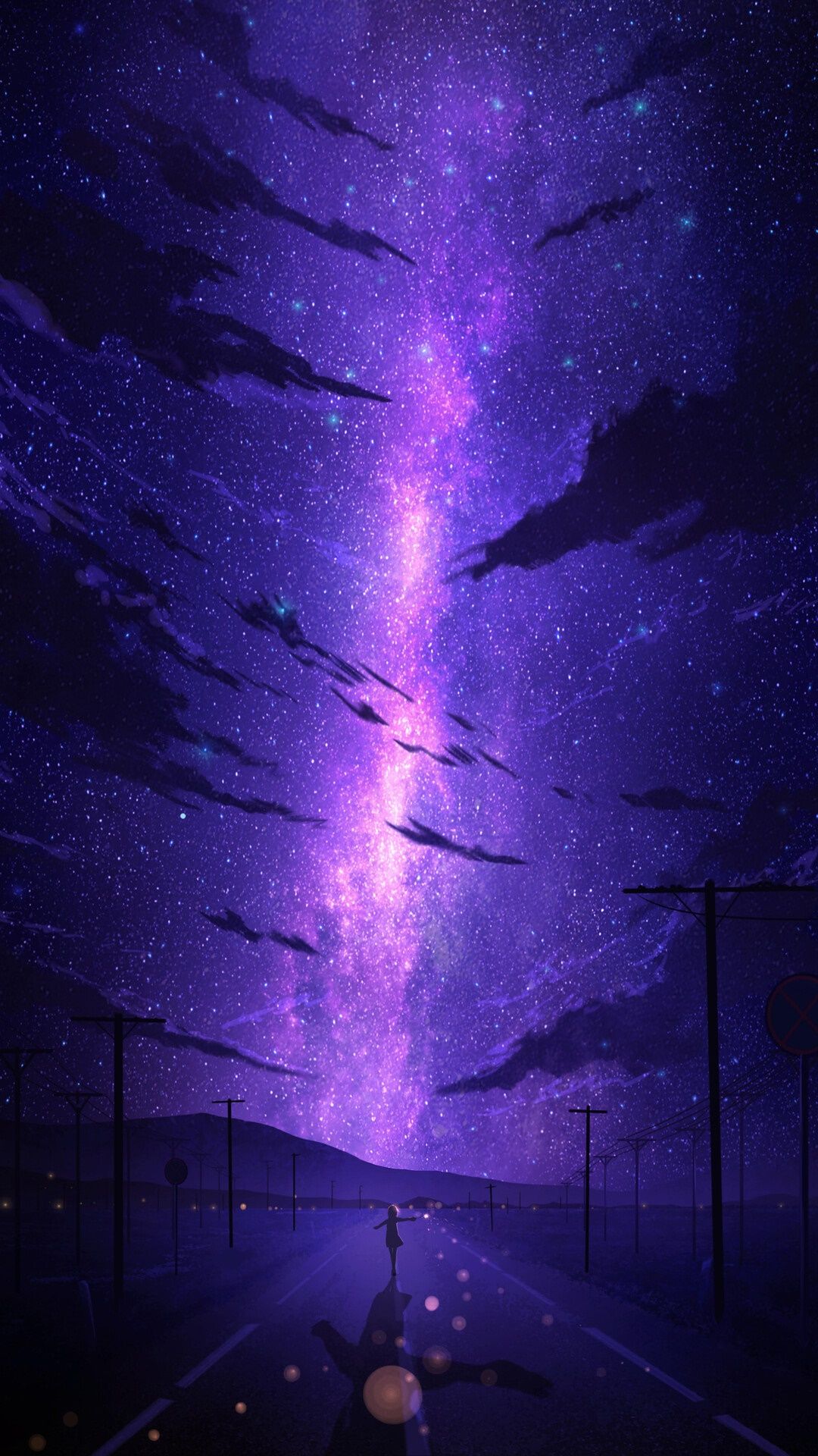 A person walking down the street underneath purple clouds - Night