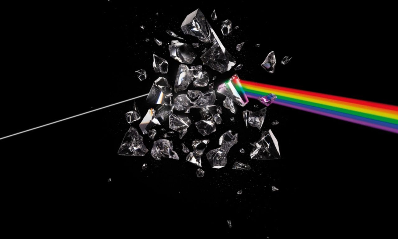 A photo of a broken glass prism with a rainbow of light shining through it. - Rainbows