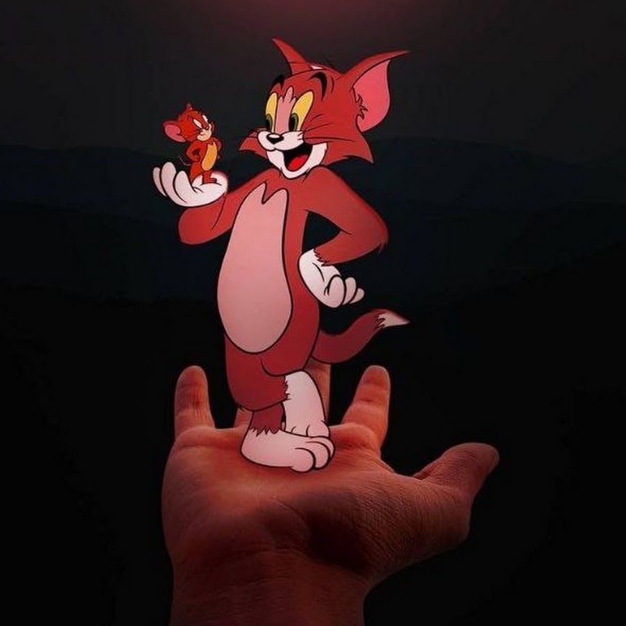 A hand holding up an image of tom and jerry - Tom and Jerry