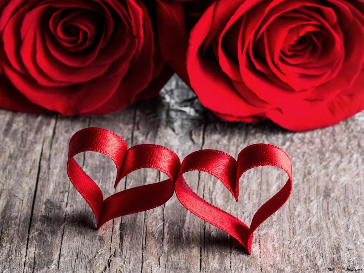 Two red roses and two red hearts on a wooden background - Roses