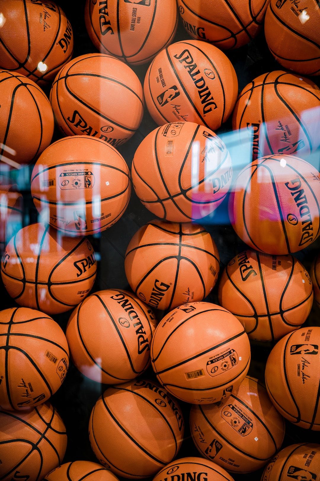 A bunch of basketballs are in the display - Basketball, NBA