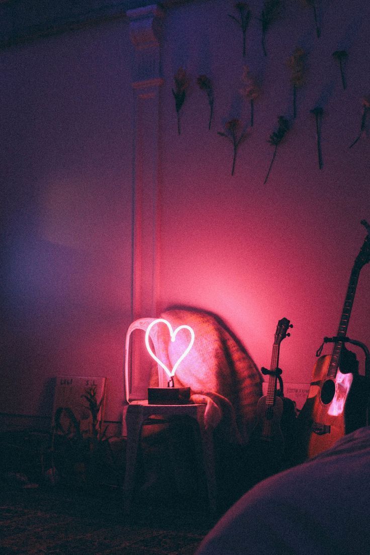 A room with pink lighting and some furniture - Neon pink