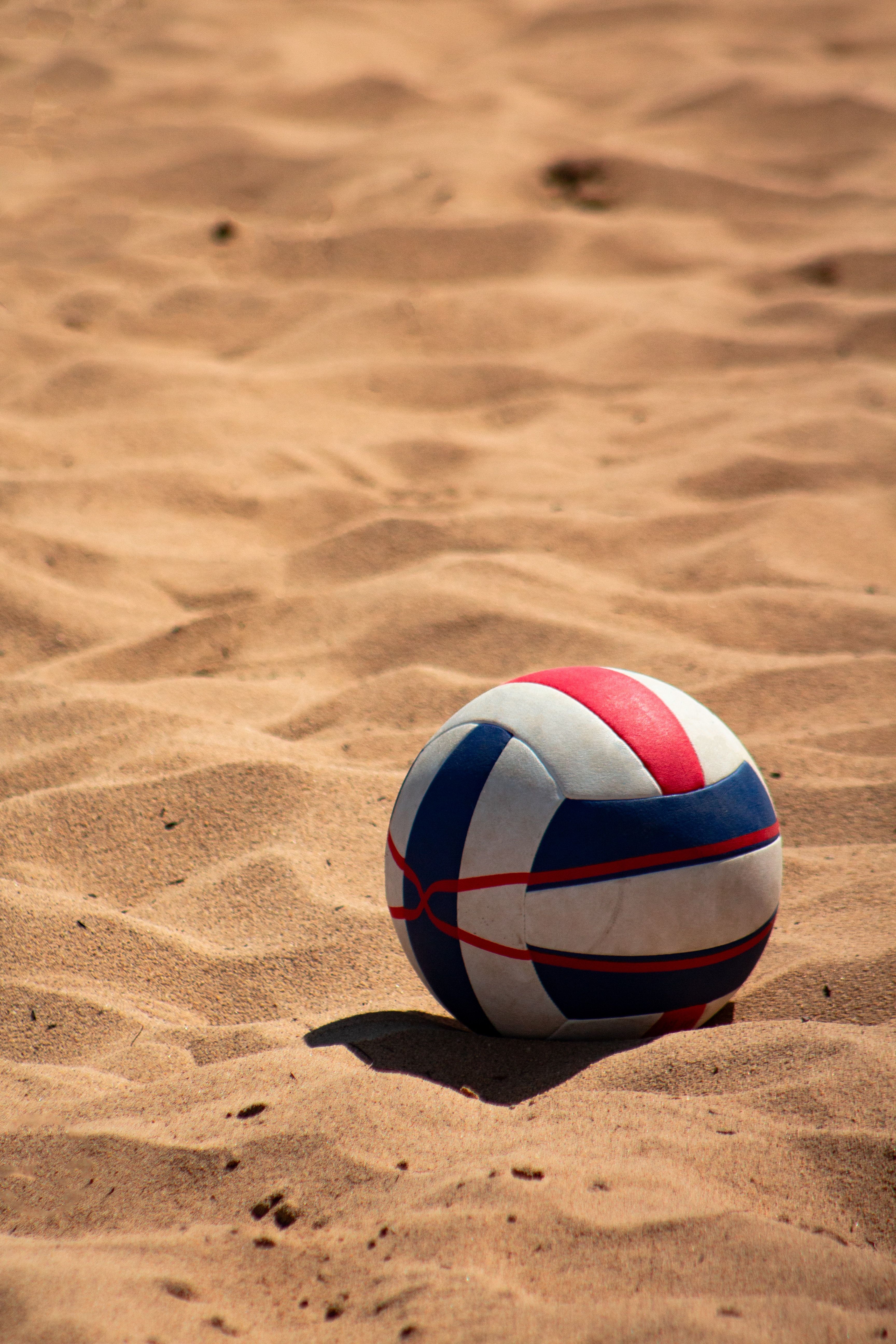 A ball is sitting on the sand - Volleyball