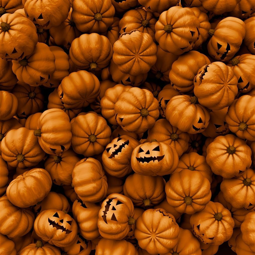 A close up of many orange pumpkins with jack o lanterns - Pumpkin