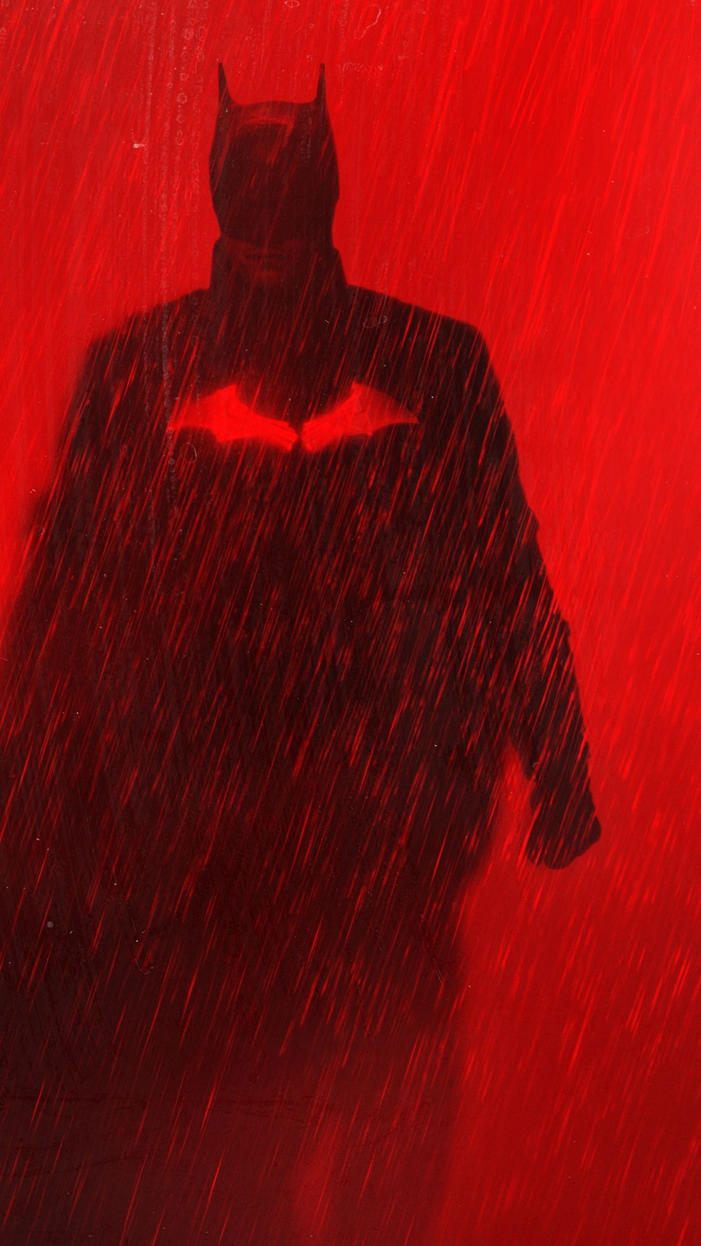 A Batman silhouette on a red background with rain. - Batman