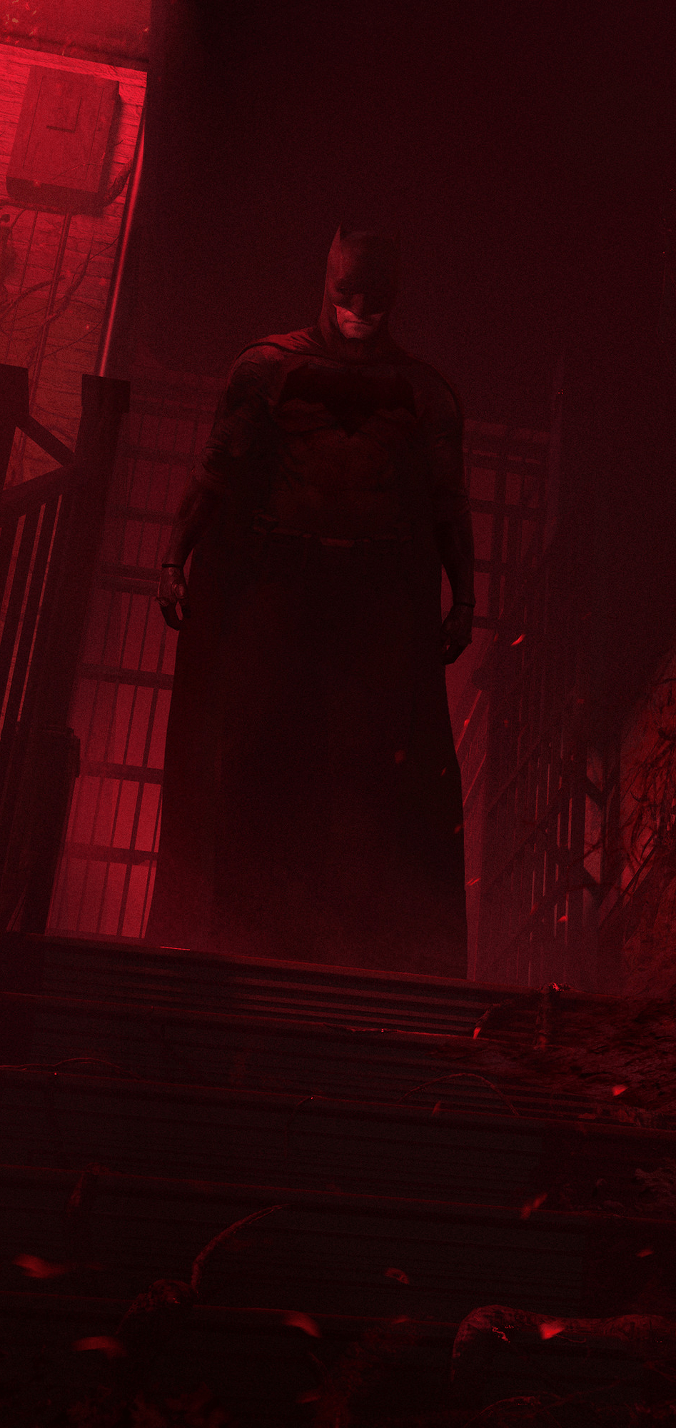 A man in dark clothing standing on stairs - Batman