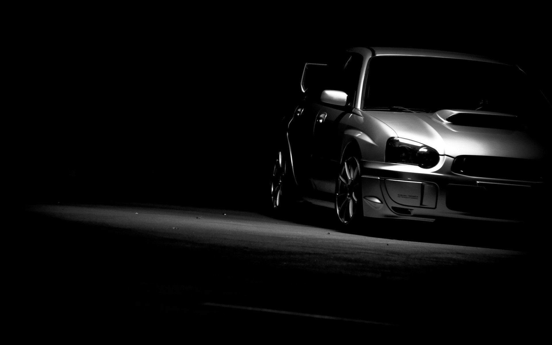A car is parked in the dark. - JDM