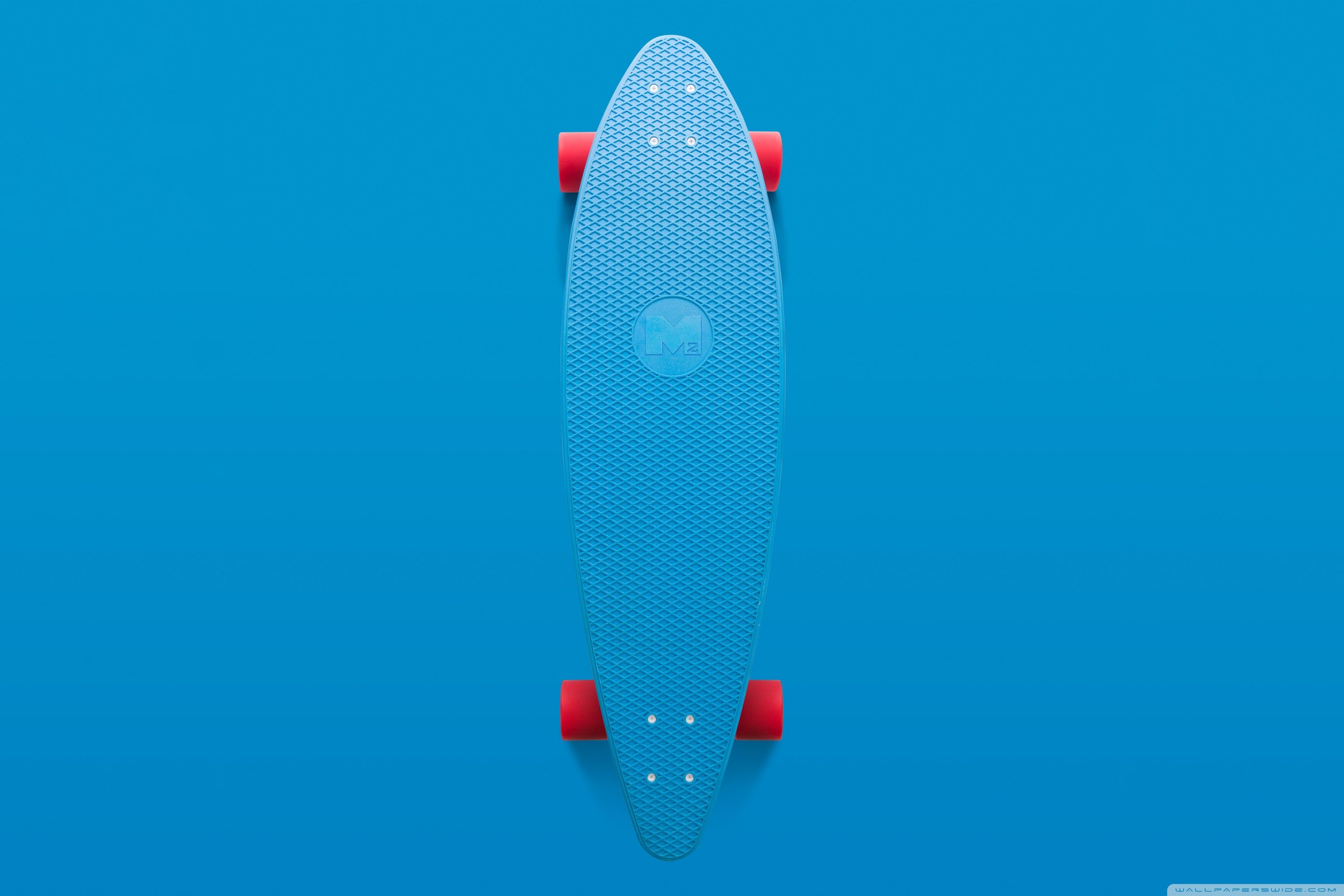 A blue skateboard with red wheels on it - Skate