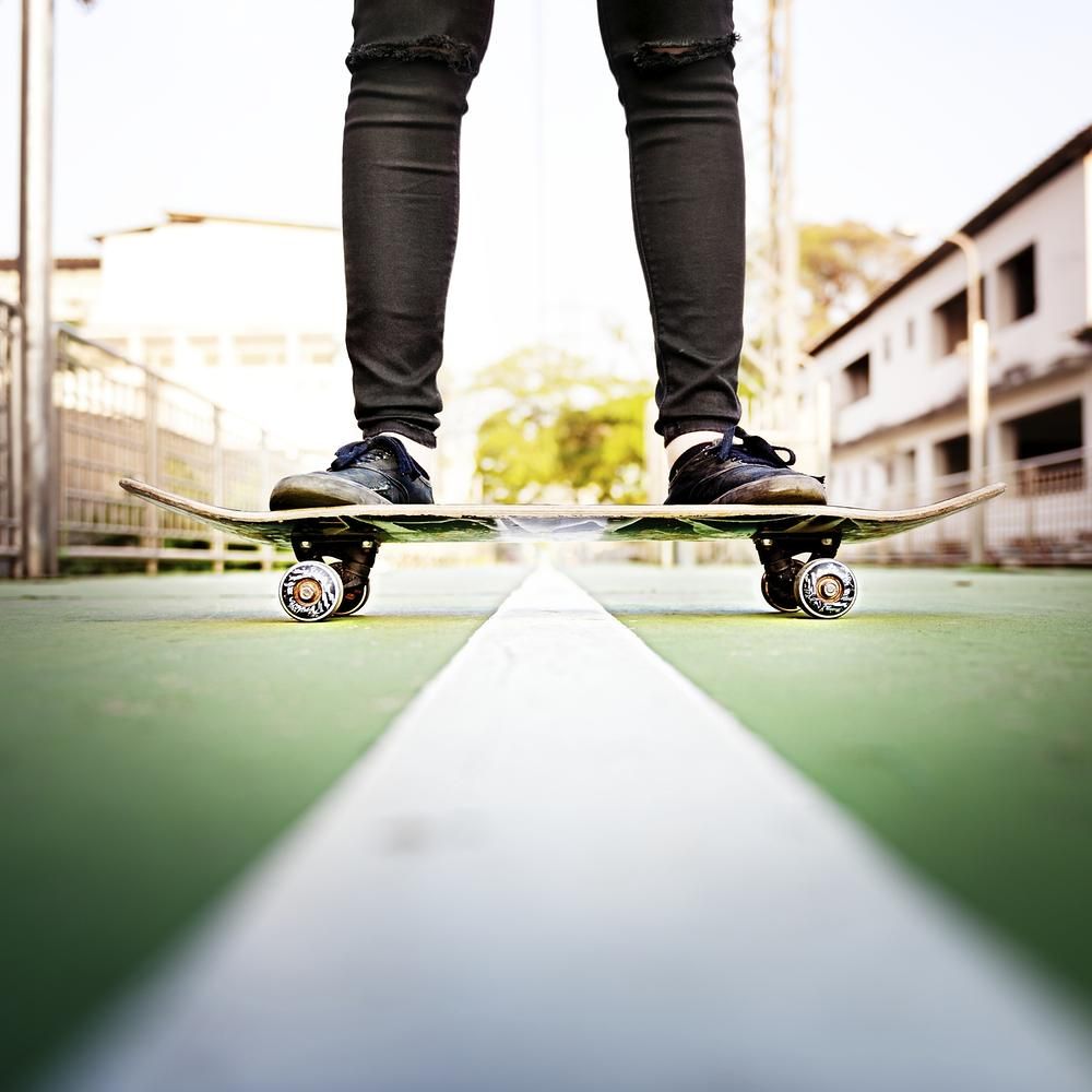 A person standing on top of skateboard - Skate