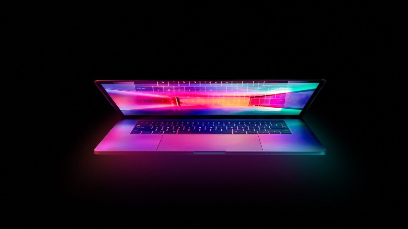 A MacBook Pro with a colorful screen and keyboard. - 1366x768