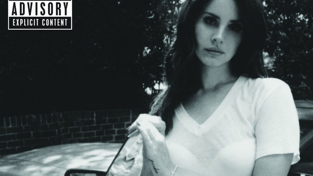 A woman is standing next to her car - Lana Del Rey