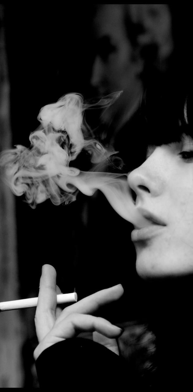 A woman smoking cigarette in black and white photo - Smoke