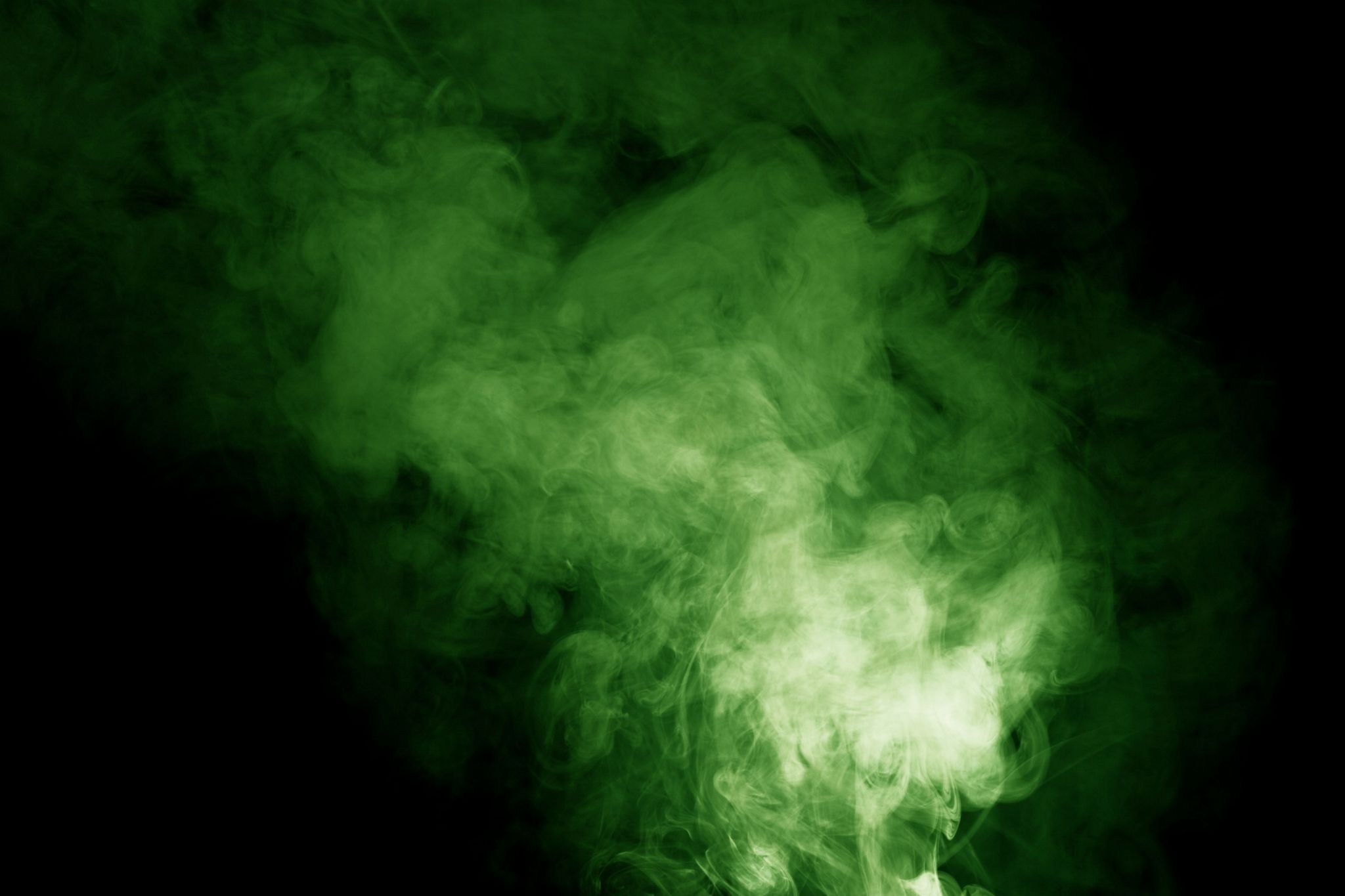 A green and white cloud of smoke against a black background - Smoke