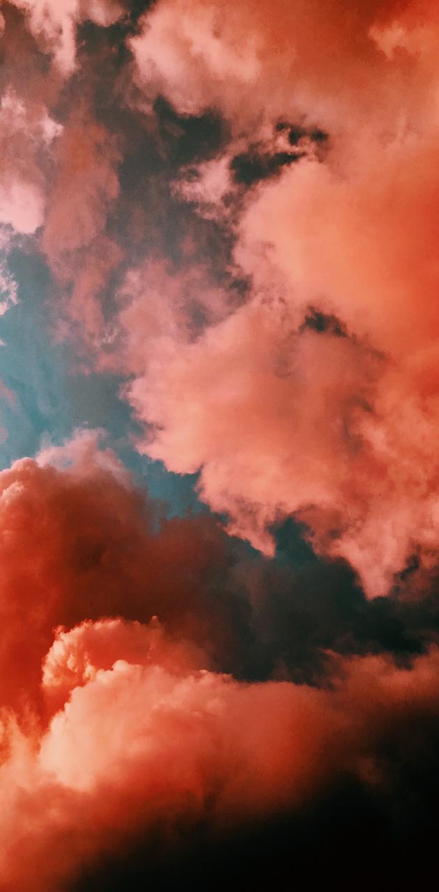 A photo of a cloudy sky with a pink tint - Smoke