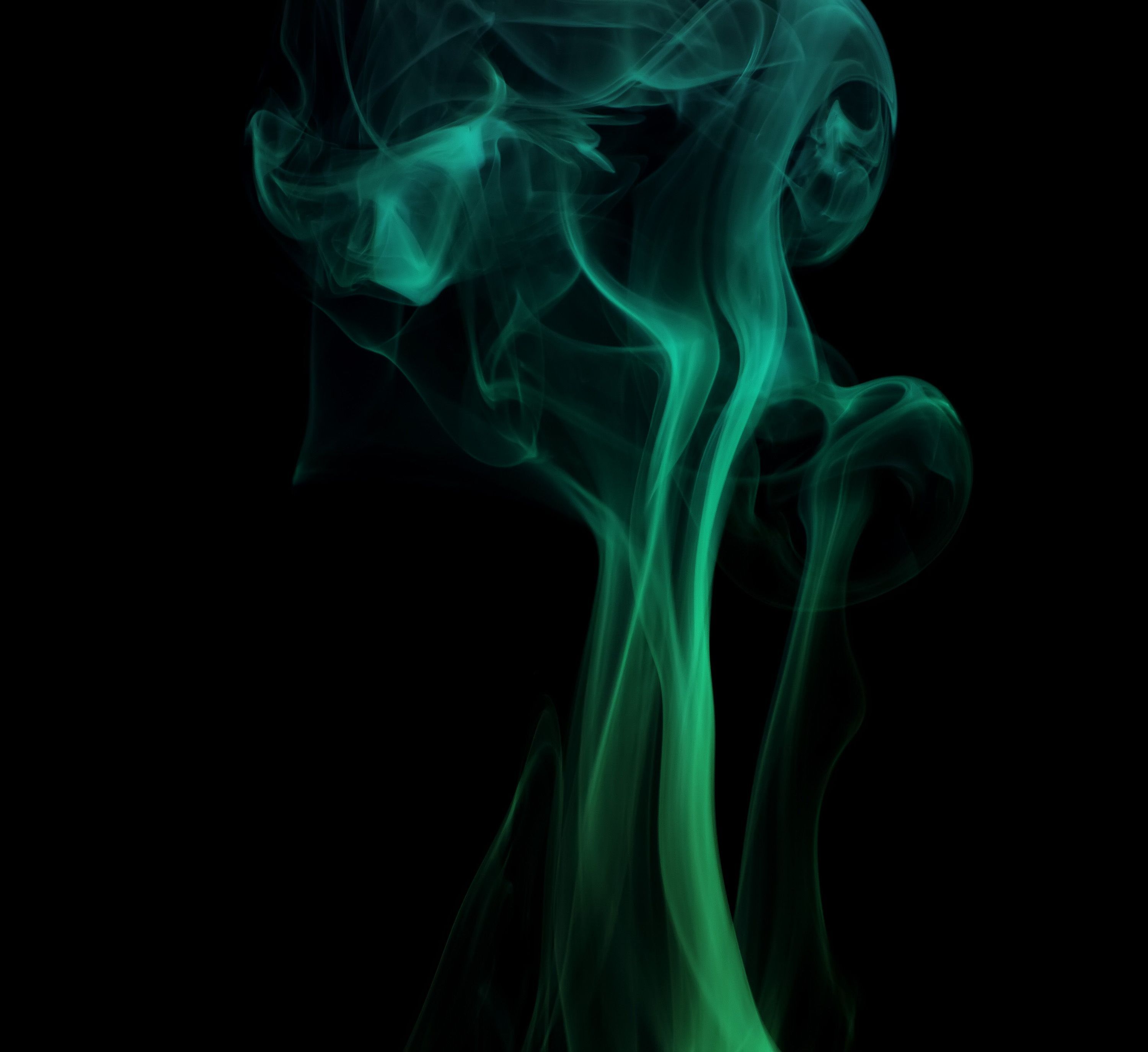 A green smoke is on top of black background - Smoke