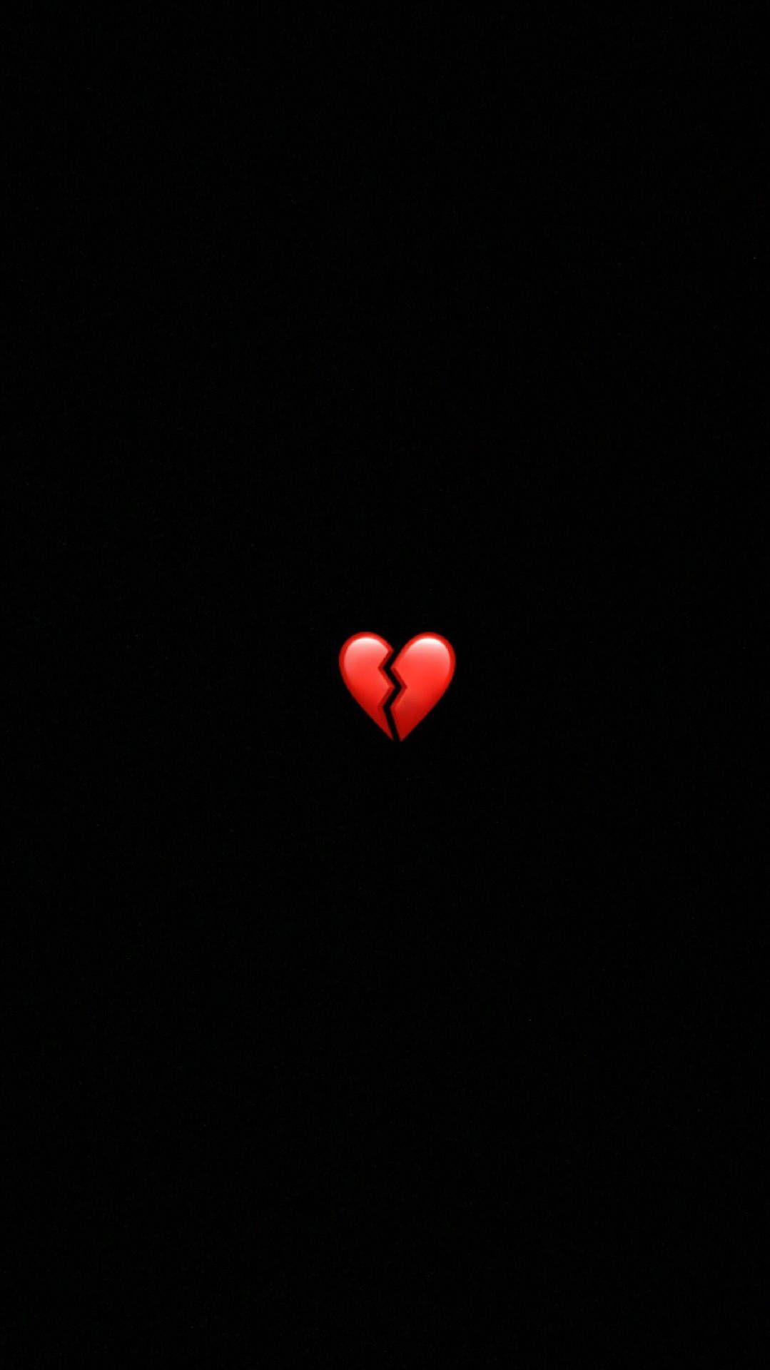 A broken heart emoji in red on a black background - Heart