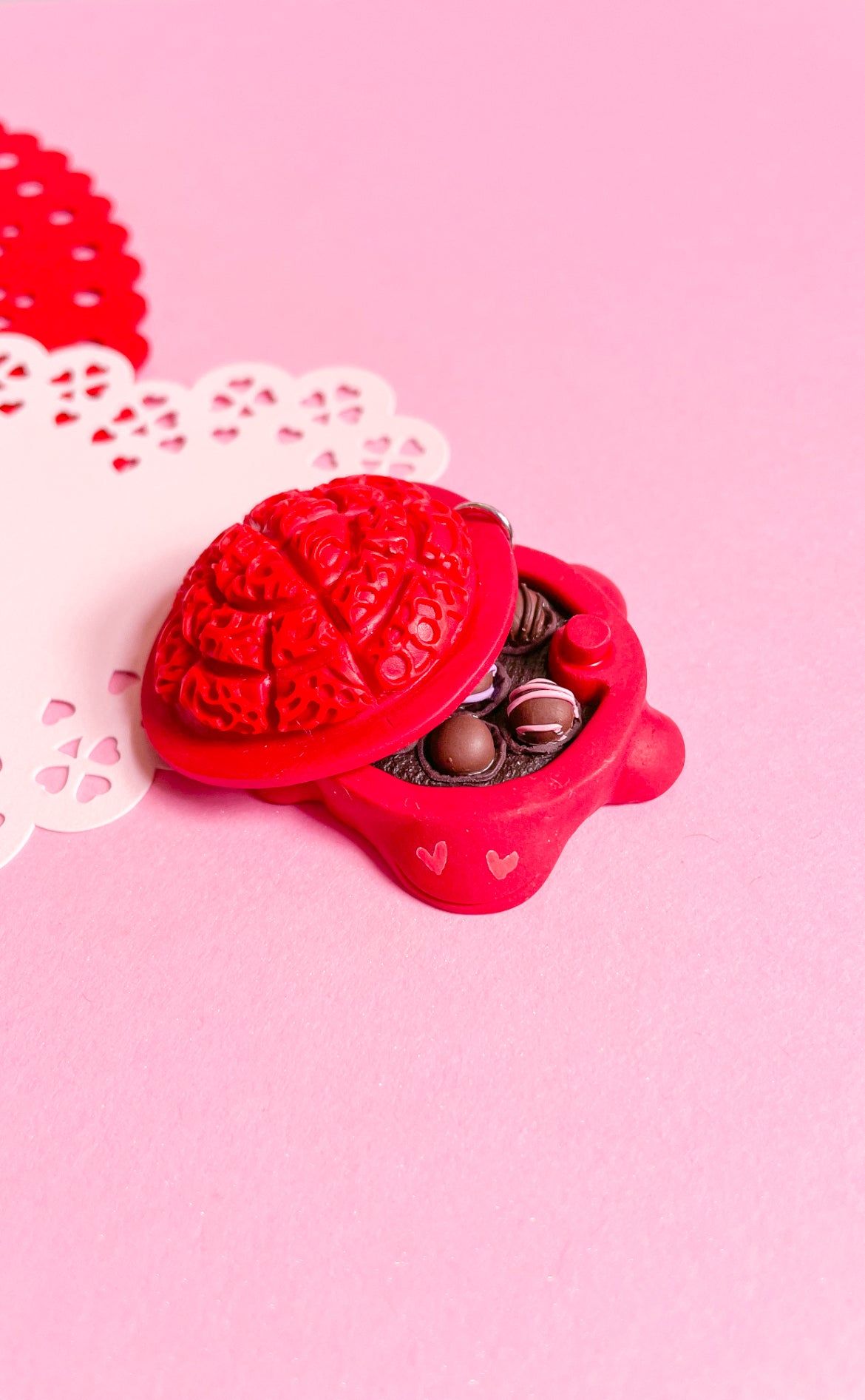 A red heart shaped box with chocolates inside - Oreo