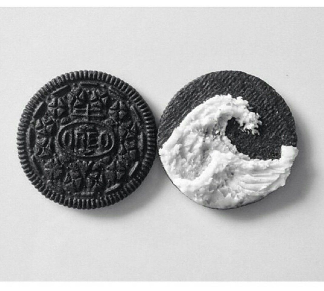 A photo of two oreo cookies, one with white filling and one with chocolate filling. - Oreo