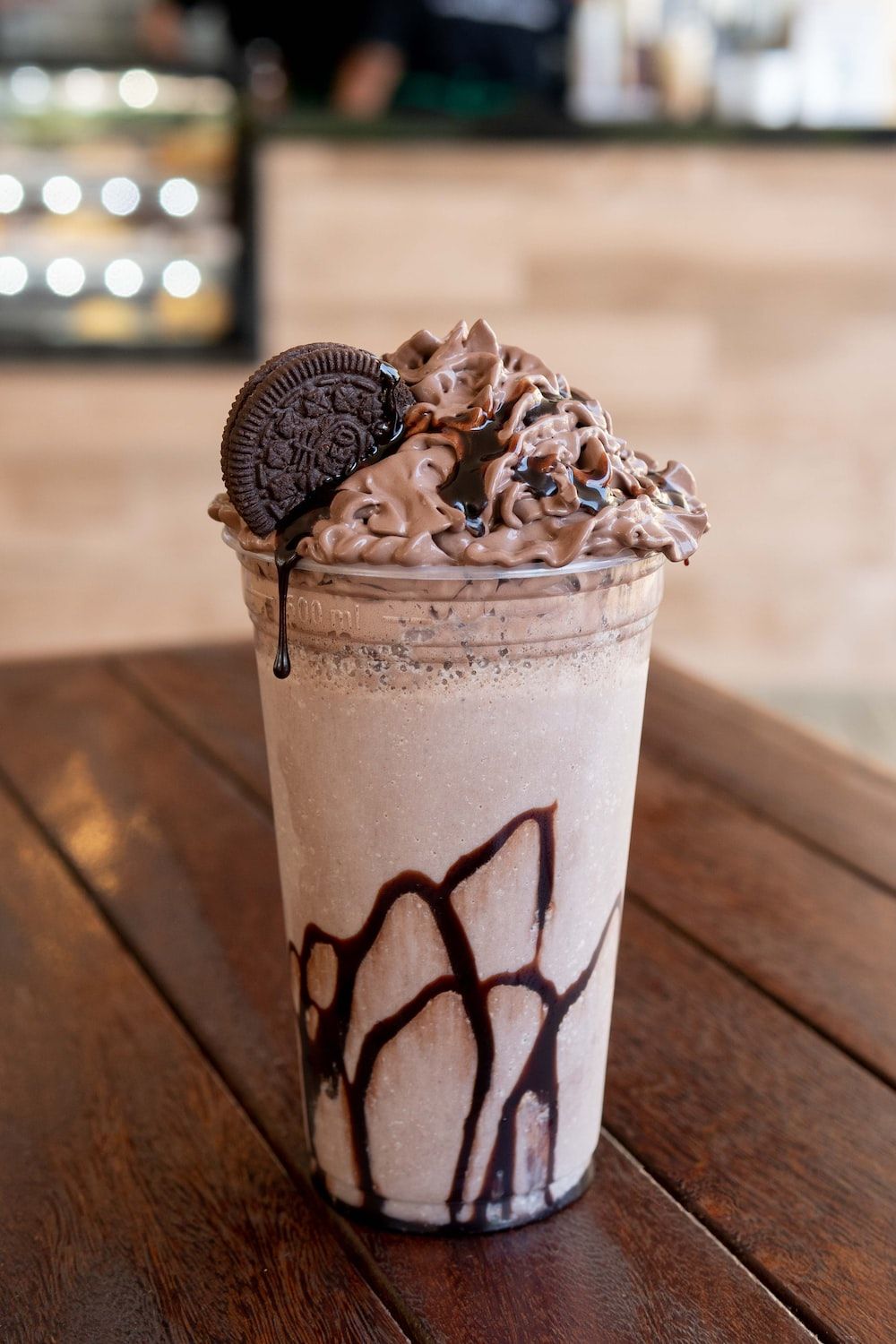 A milkshake with Oreo cookie and chocolate drizzle on top - Oreo