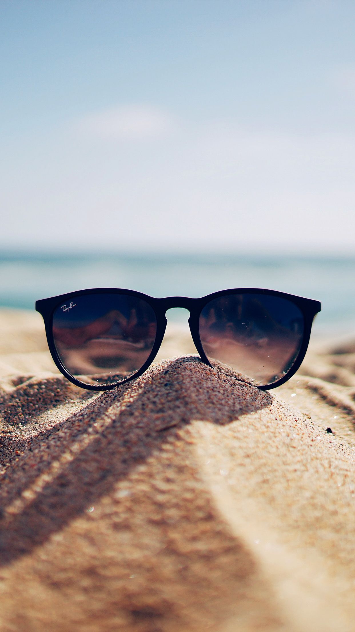 A pair of sunglasses on the sand - Sun