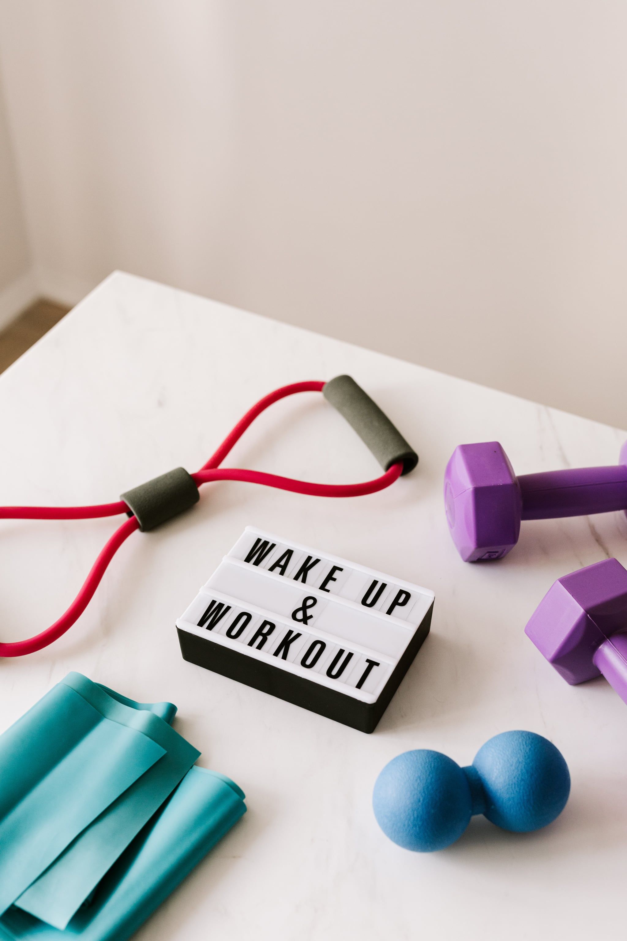 A table with exercise equipment and weights - Gym