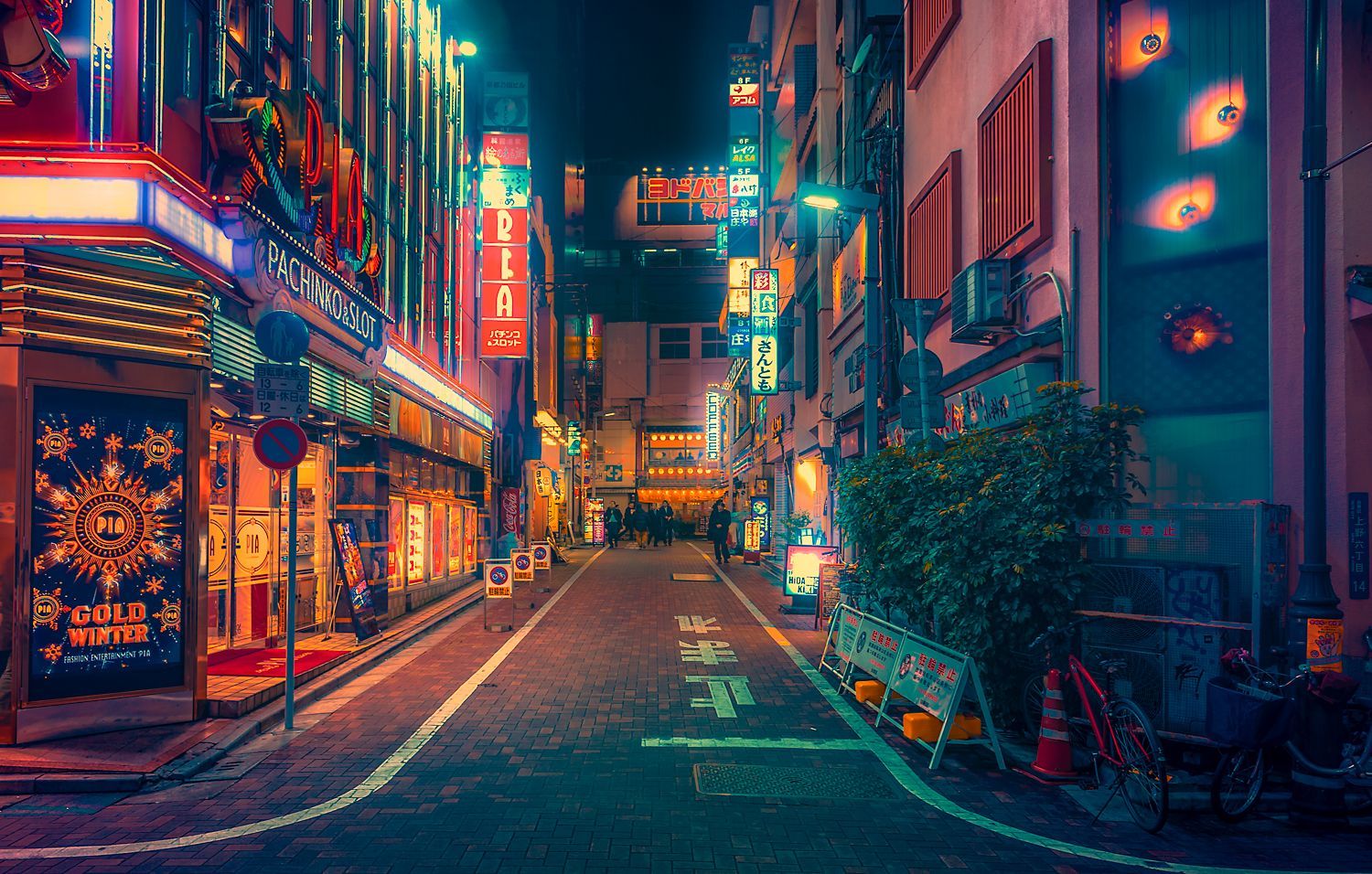 A street in Tokyo at night with neon lights and colorful signs. - Tokyo