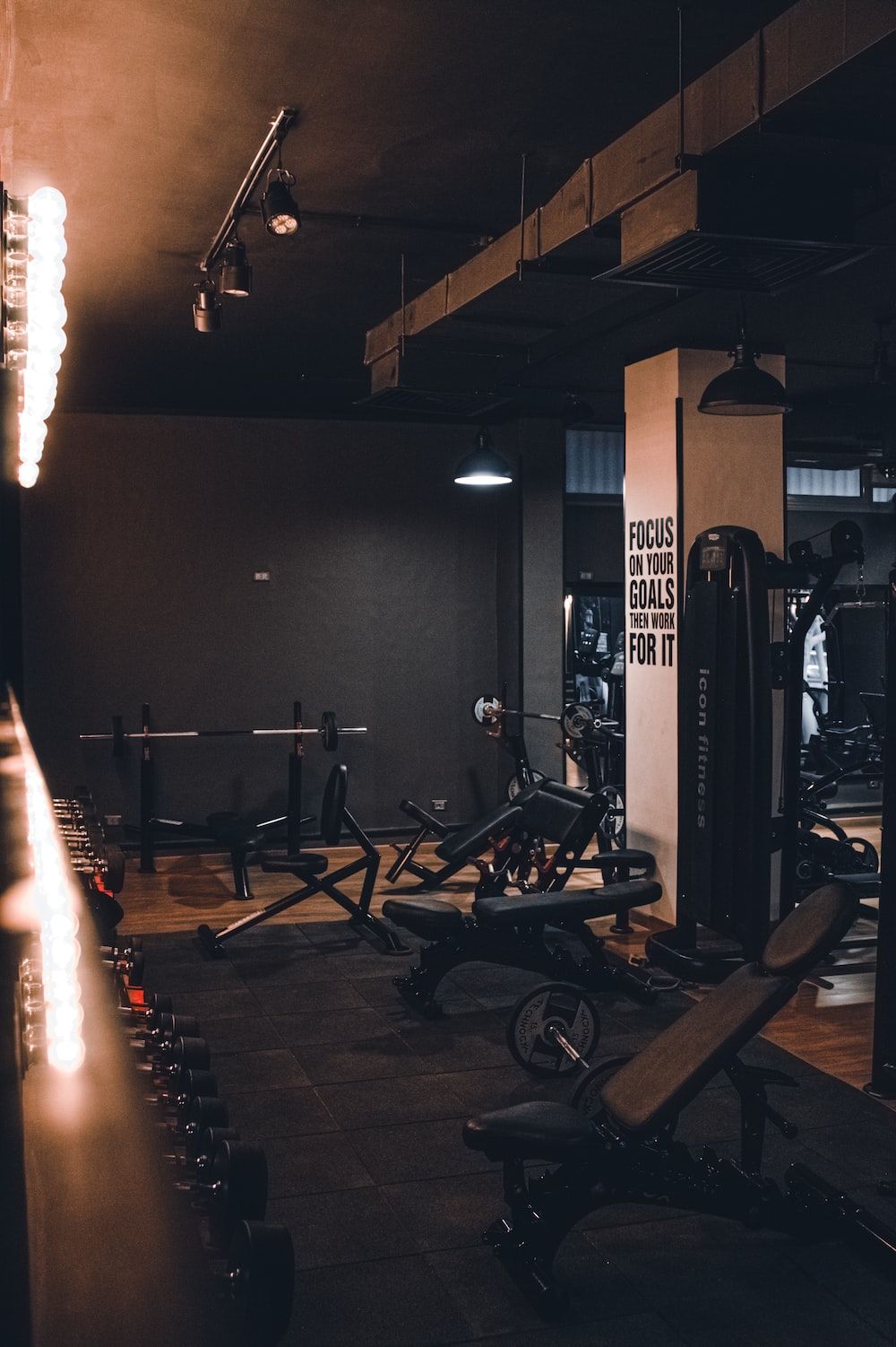 A gym with lots of equipment and lights - Gym