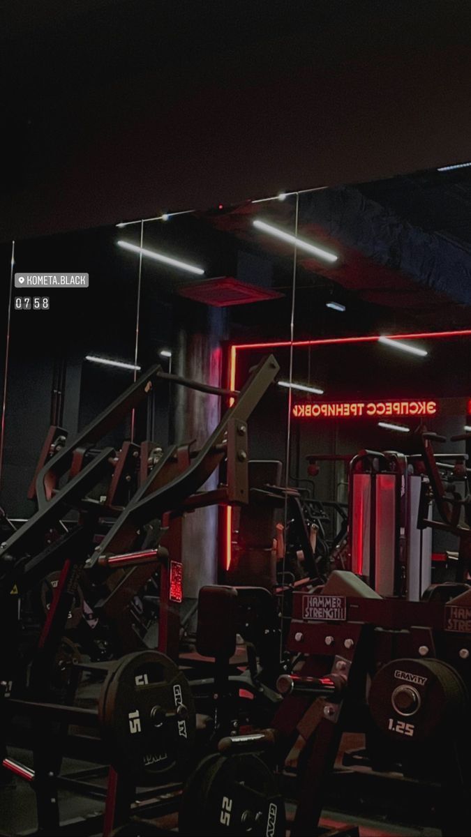 The gym is well lit with red lights - Gym