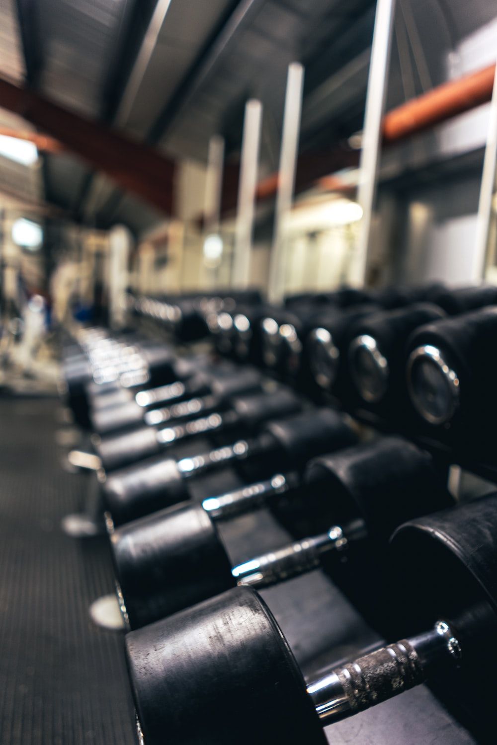 A gym with many dumbbells on the floor - Gym