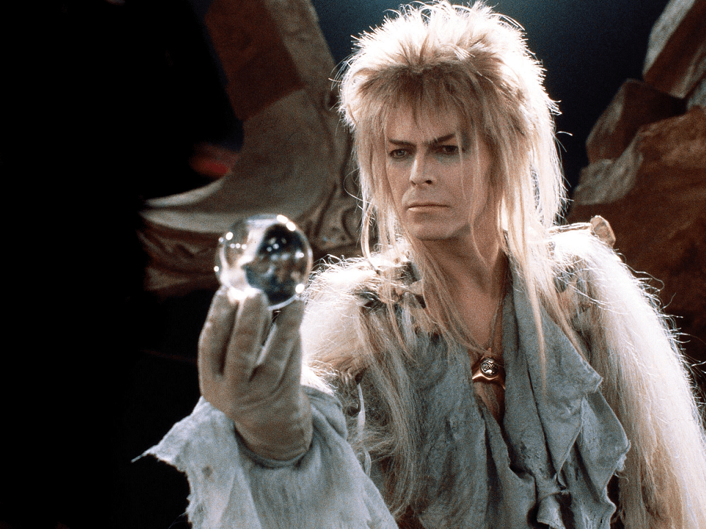 A man with long hair holding up an orb - David Bowie