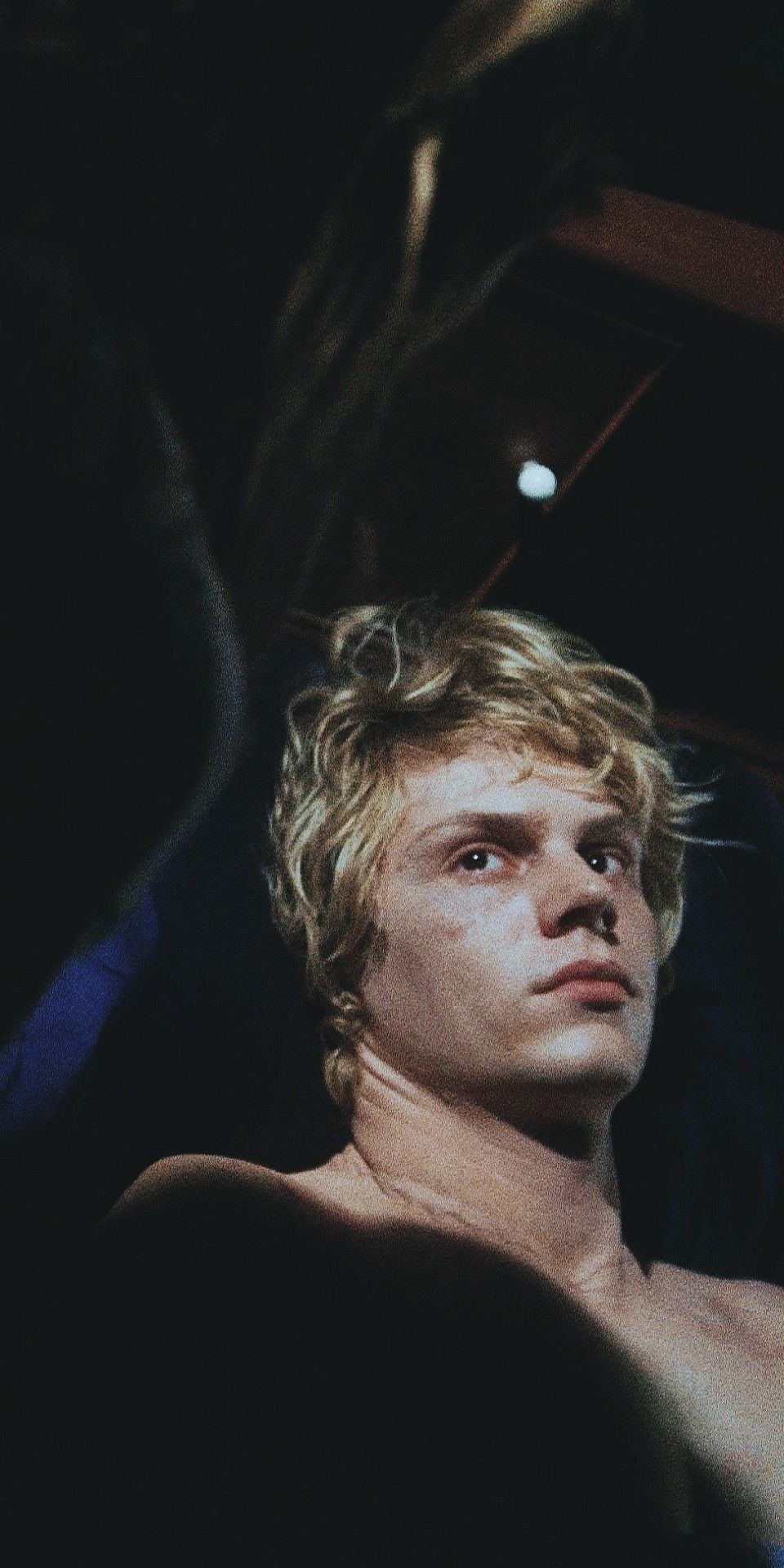 The image is a close-up of a shirtless male model with blonde hair. - Evan Peters