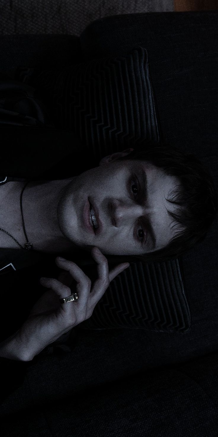 A man laying on the couch with his eyes closed - Evan Peters